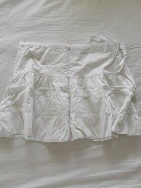 White ruffle mini skirt with side tie on waist